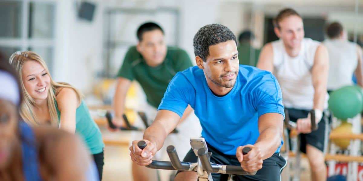 Man sat on exercise bike.