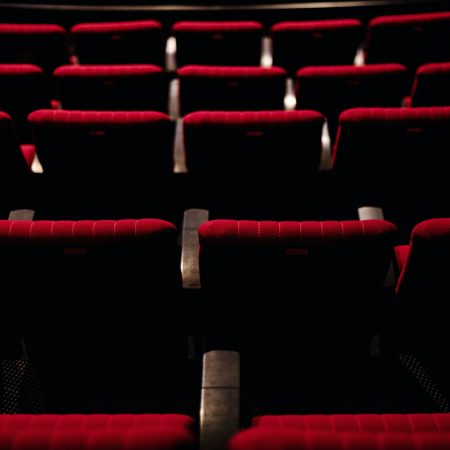 Rows of red seats in a theatre