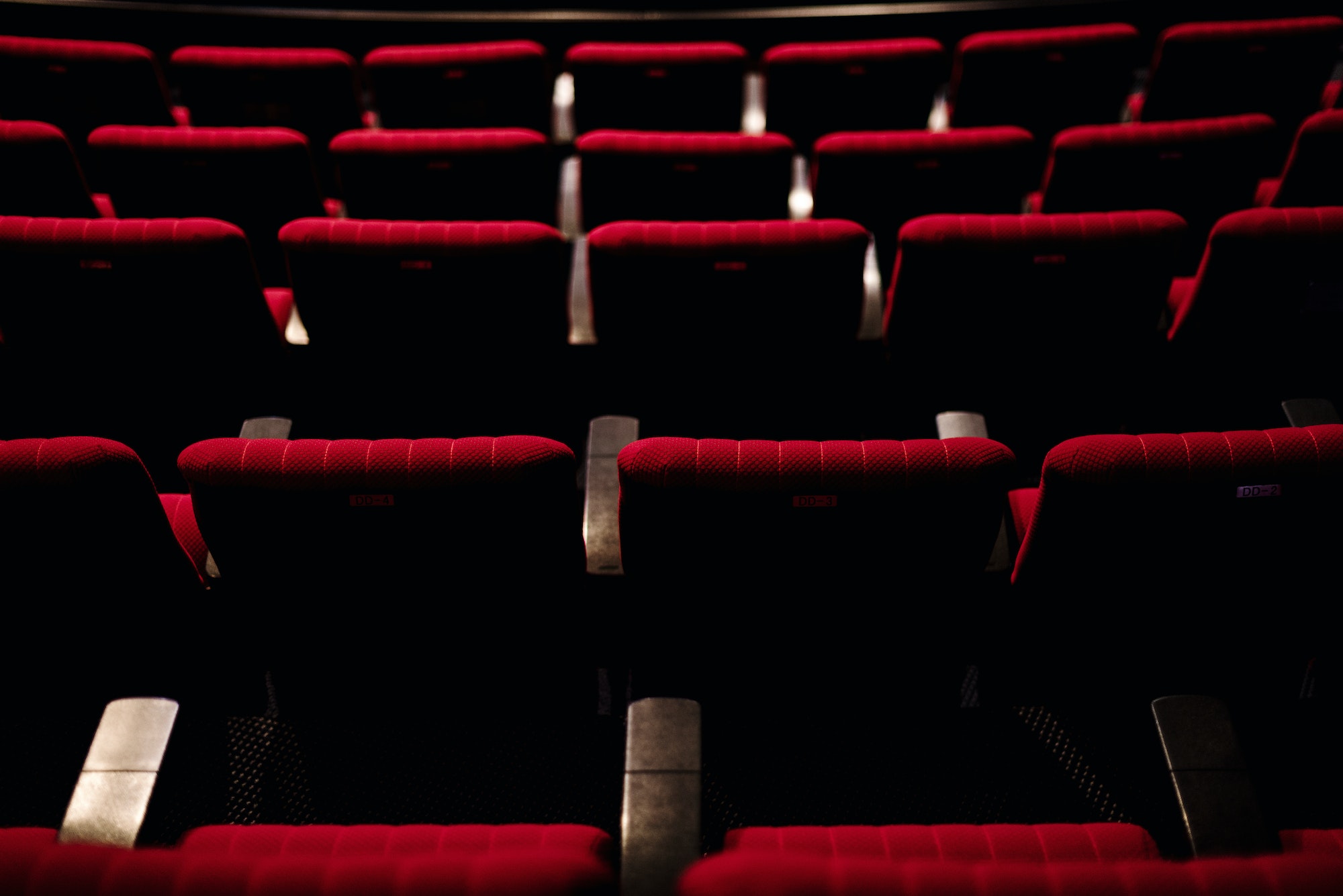 Rows of red seats in a theatre